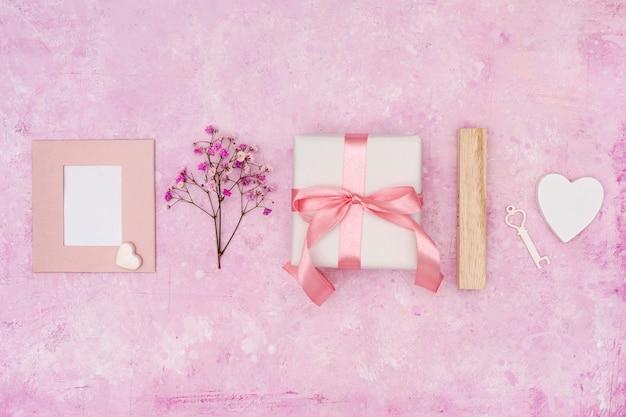 Flat lay arrangement with present on pink background