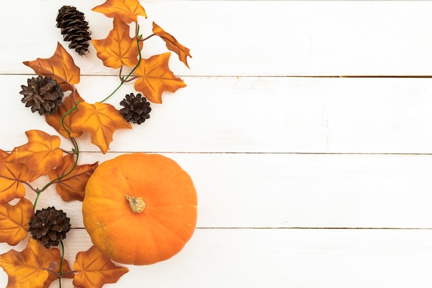 Flat lay arrangement with pumpkin and leaves