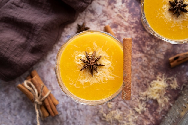 Flat lay arrangement with tasty drink and cinnamon stick