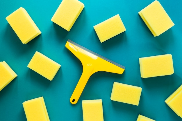 Flat lay arrangement with yellow sponges on blue background