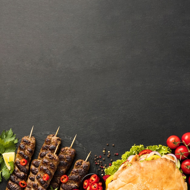 Free photo flat lay of assortment of tasty kebabs with copy space