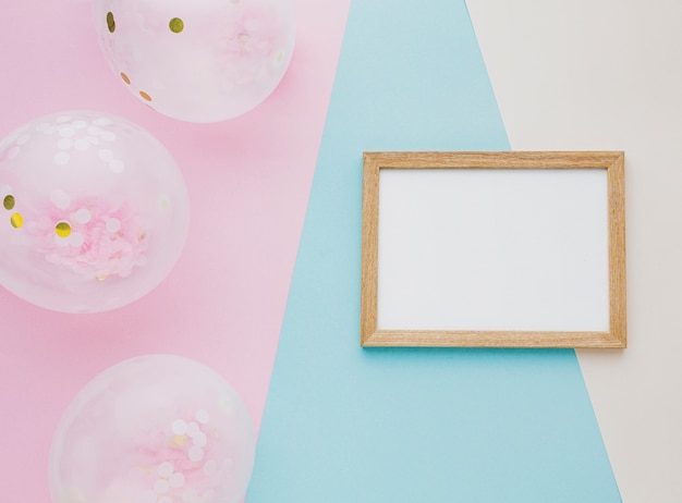 Flat lay assortment with balloons and frame