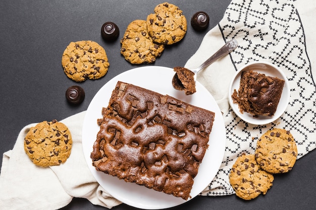 Free Photo flat lay assortment with chocolate cake and cookies