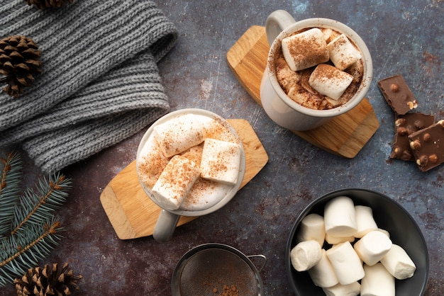 Flat lay assortment with mugs with tasty beverage