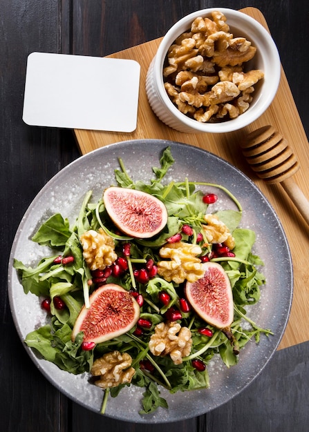 Free Photo flat lay of autumn fig salad on plate with walnuts