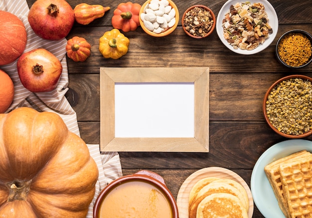 Flat lay autumn food on striped sheet with frame