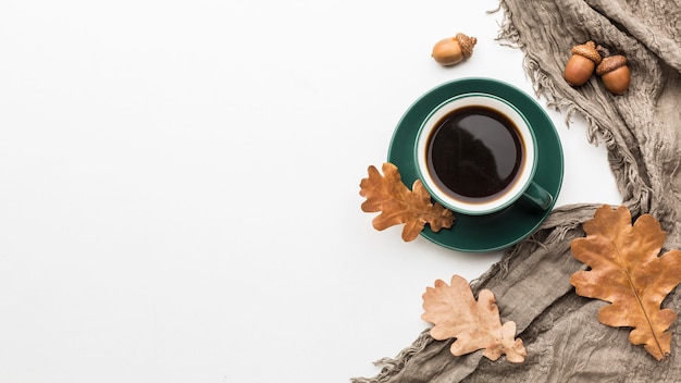 Flat lay of autumn leaves with coffee cup and copy space