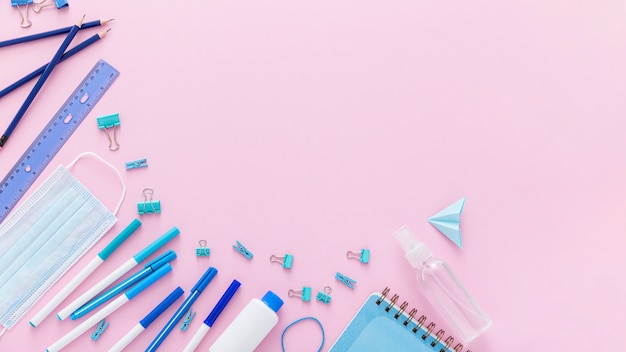 Flat lay of back to school materials with hand sanitizer and copy space