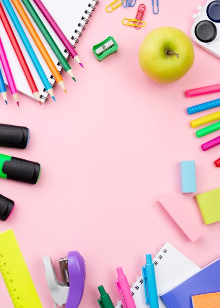 Flat lay of back to school stationery with apple and colorful pencils