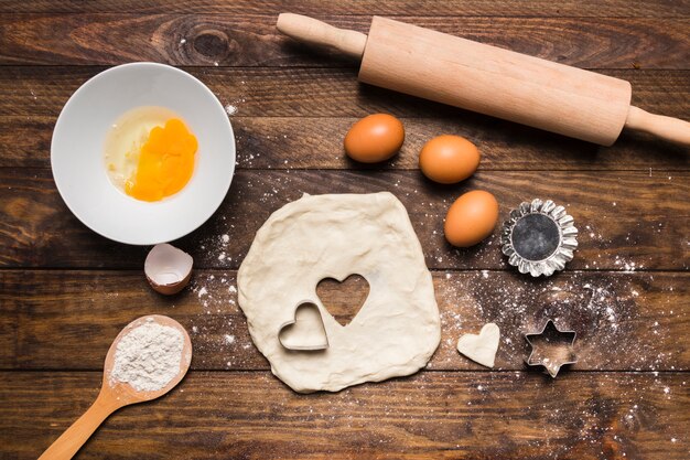 Flat lay bakery composition with dough and eggs