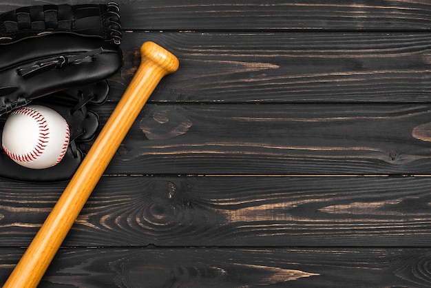 Flat lay of baseball bat with glove and ball