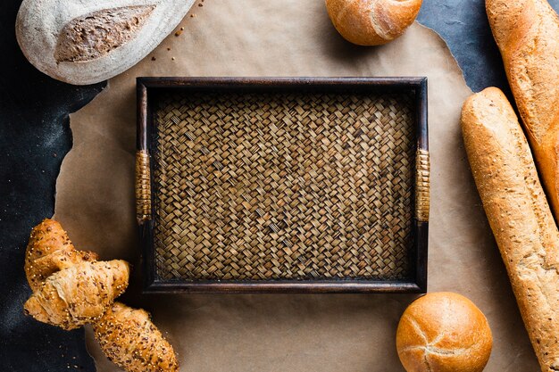 Flat lay of basket and bread on baking sheet