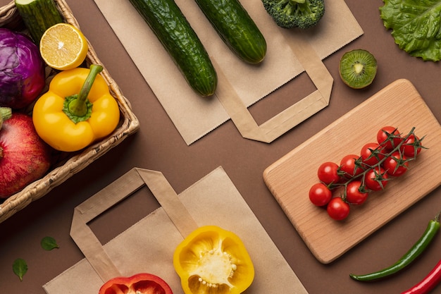 Free photo flat lay of basket of organic vegetables with grocery bag