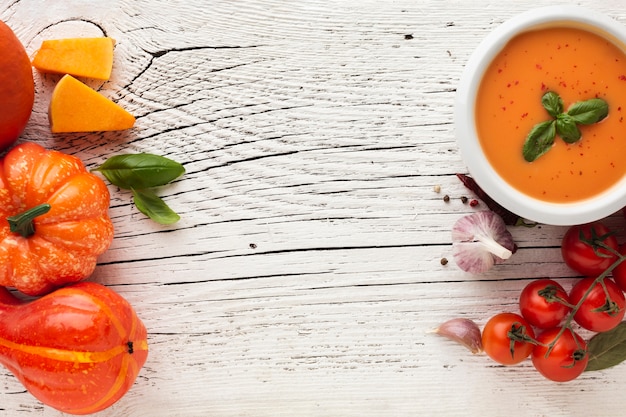 Flat lay bisque and vegetables with copy space