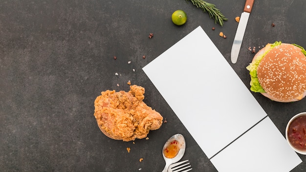 Free photo flat lay of blank menu paper with burger and fried chicken