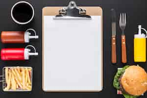 Free photo flat lay of blank menu with burger and sauces