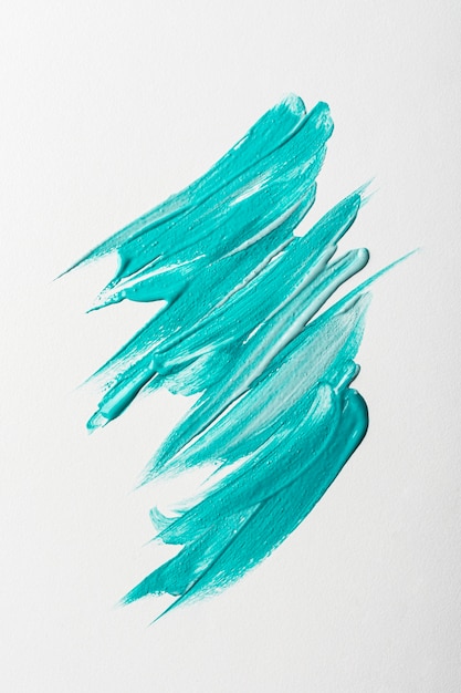 Free photo flat lay of blue paint brush strokes on surface