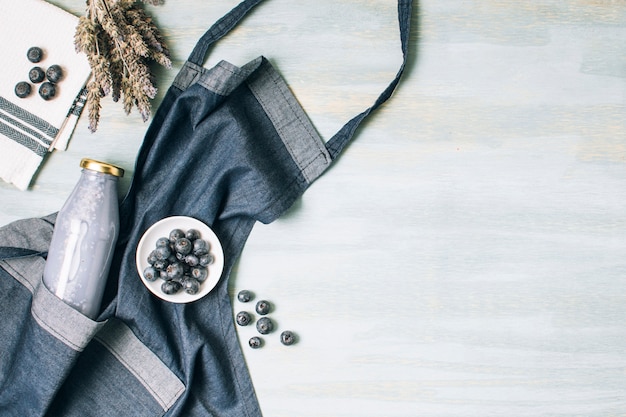 Free Photo flat lay blue smoothie and apron with copy space