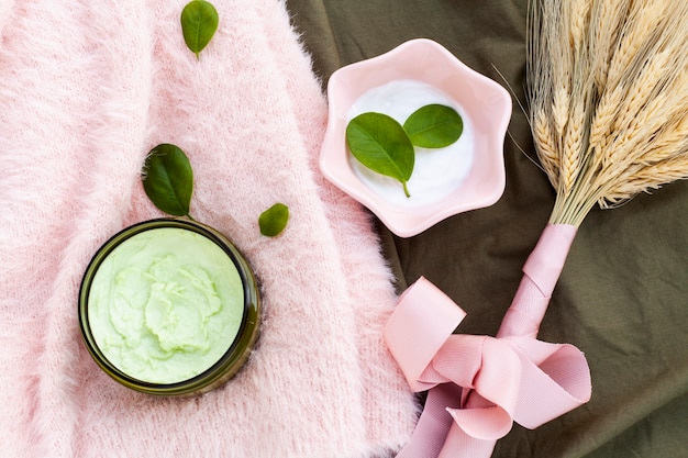 Free photo flat lay of body butter on pink cloth