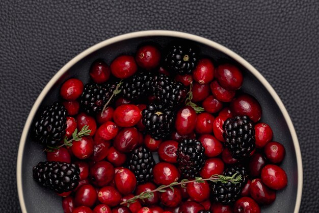 Flat lay of bowl with blackberries and cranberries