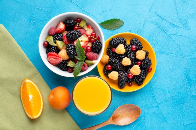 Free Photo flat-lay of bowls of berries and fruits