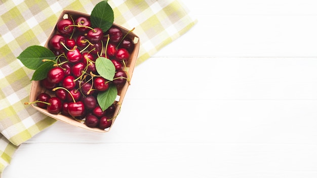 Flat-lay box of berries on tablecloth