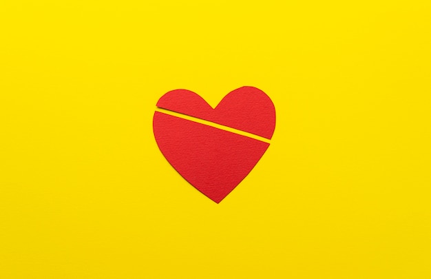 Free Photo flat lay broken heart on yellow background