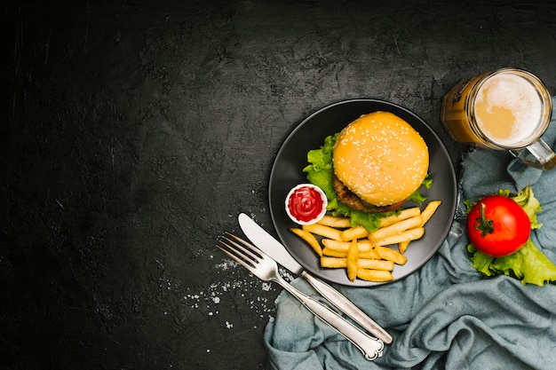 Flat-lay burger and fries on plate with copyspace