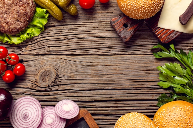 Flat lay burger ingredients on wooden table