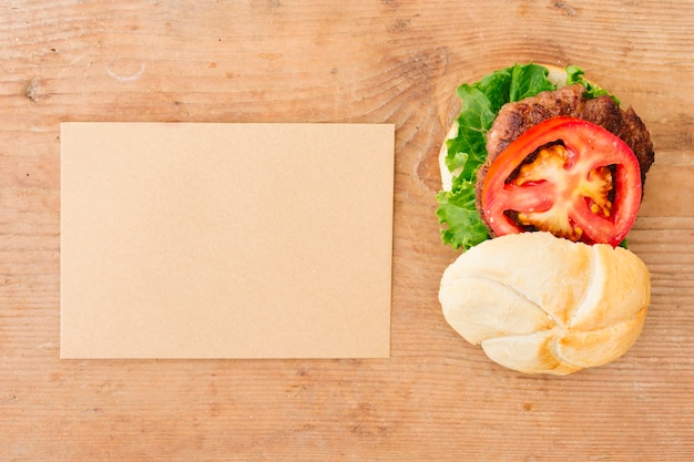 Flat-lay burger on slate with cardboard