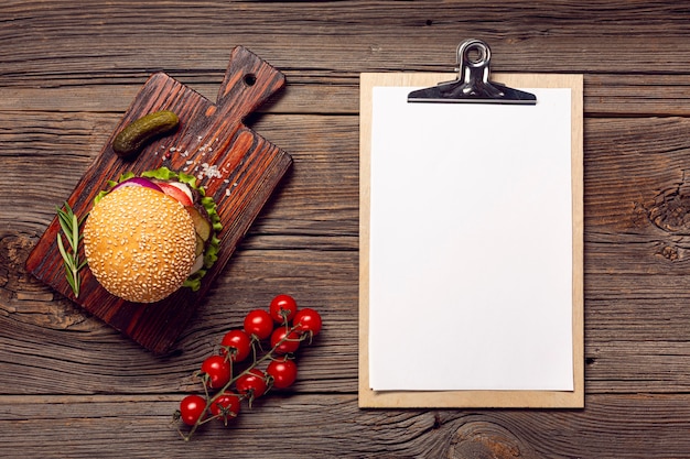 Free Photo flat lay burger with mock-up clipboard