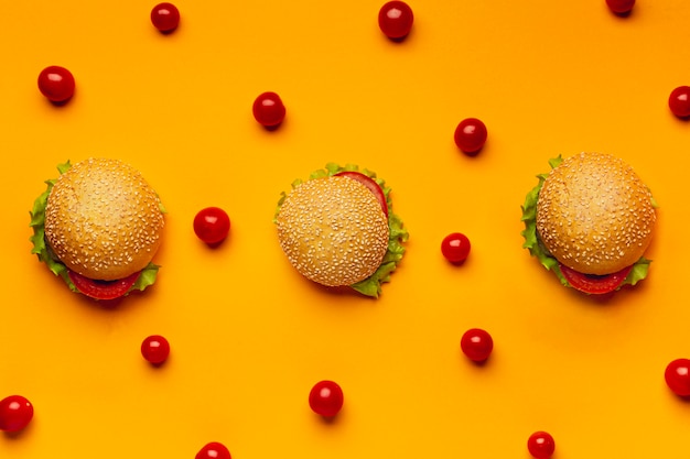 Flat lay burgers with cherry tomatoes