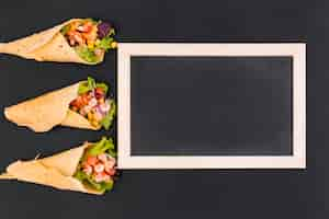 Free photo flat lay of burritos and slate