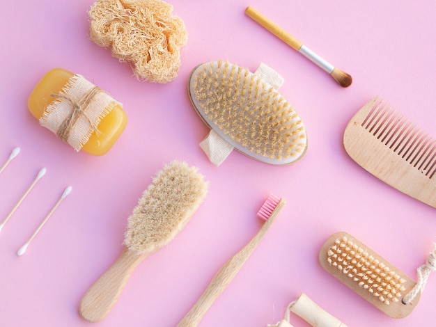 Flat lay care products on pink background