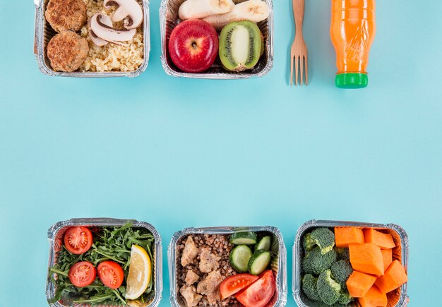 Flat lay of casseroles with fruits and meals