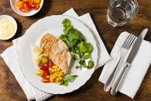 Free photo flat lay of chicken breast with assortment of vegetables