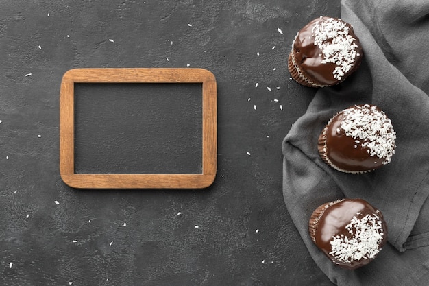 Flat lay of chocolate desserts with blackboard