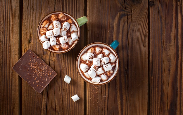 Flat lay chocolate tablet and hot chocolates with marshmallows