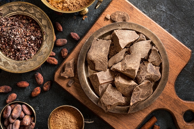 Flat lay of chocolate with cocoa beans and powder