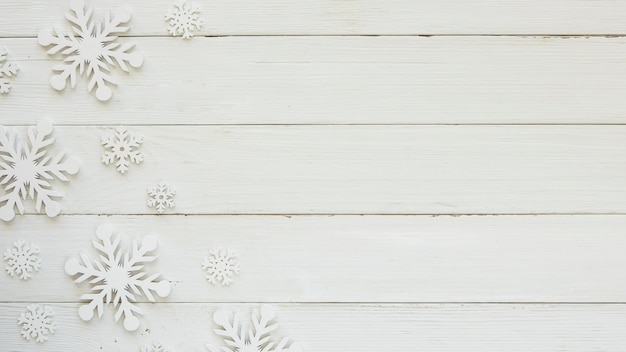 Flat lay christmas decorative snowflakes on wooden board