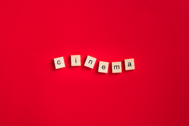 Free Photo flat lay cinema lettering on red background