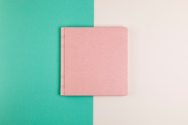 Flat lay closed book with colourful background