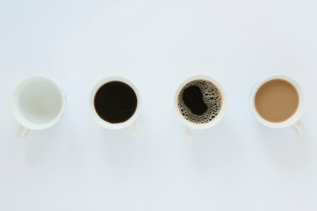 Free photo flat lay of coffee cups on white table