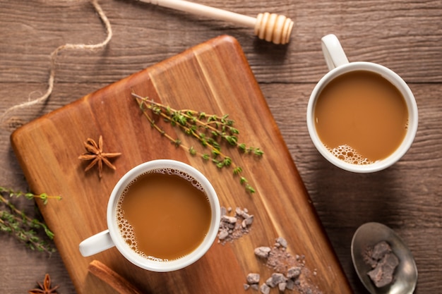 Flat lay coffee cups on wooden board