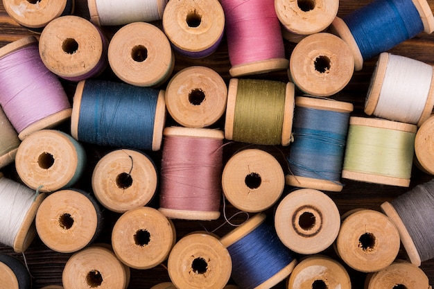 Free photo flat lay of colored thread spools