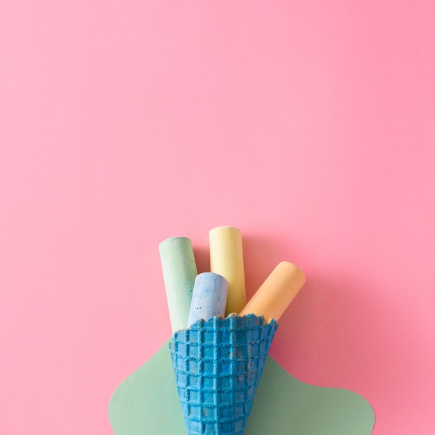 Free photo flat lay of colorful chalk on pink background with copy space