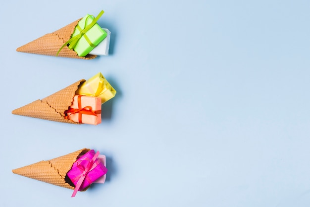 Free photo flat lay of colorful gifts in ice cream cones