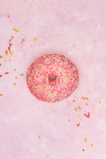 Free Photo flat lay of colorful glazed doughnut with sprinkles