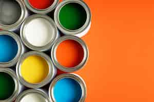 Free photo flat lay colorful paint cans