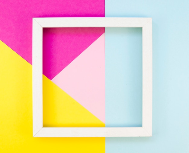 Free photo flat lay of colorful paper geometry with frame